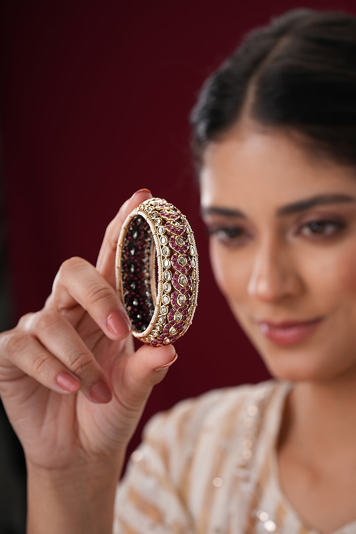 Gold Finish Kundan Polki & Red Stone Bangles (Set Of 2) by EKATHVA JAIPUR at Pernia's Pop Up Shop