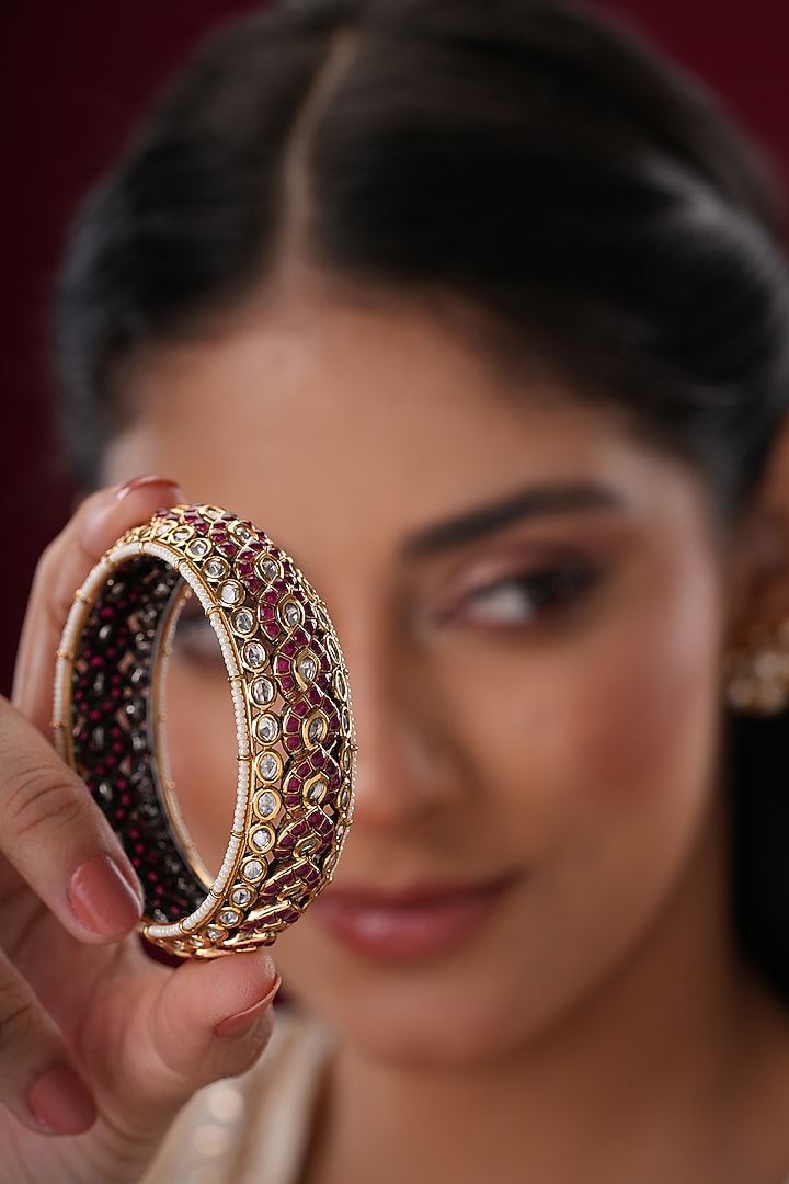 Gold Finish Kundan Polki & Red Stone Bangles (Set Of 2) by EKATHVA JAIPUR at Pernia's Pop Up Shop