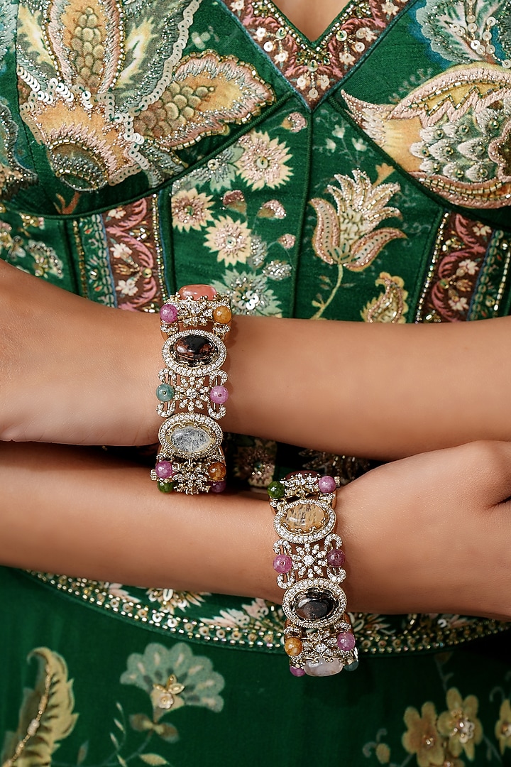 Gold Finish Navratna Stone Bangles (Set Of 2) by EKATHVA JAIPUR at Pernia's Pop Up Shop