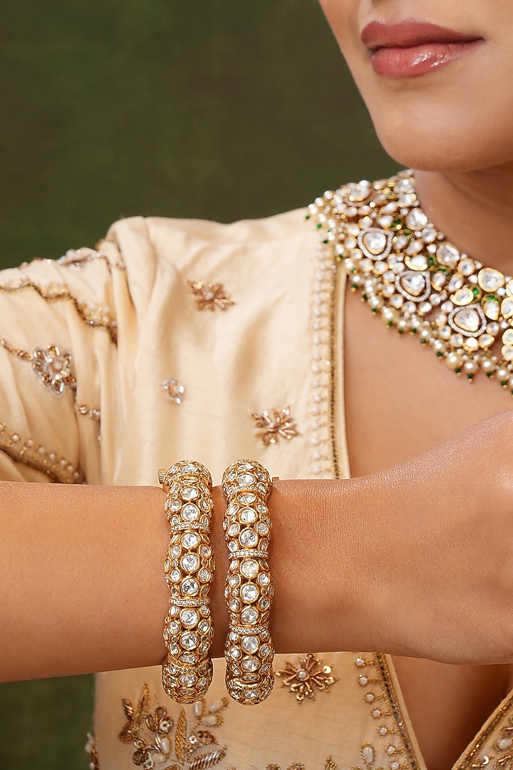 Gold Finish Kundan Polki Bangles (Set Of 2) by EKATHVA JAIPUR at Pernia's Pop Up Shop
