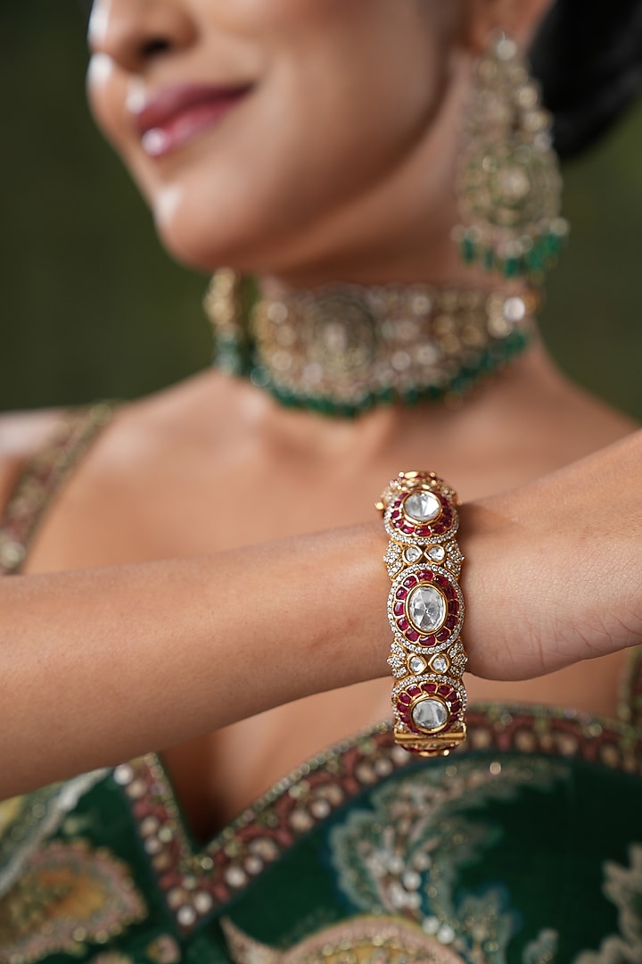 Gold Finish Cubic Zirconia & Red Tourmaline Stone Bangles (Set Of 2) by EKATHVA JAIPUR at Pernia's Pop Up Shop