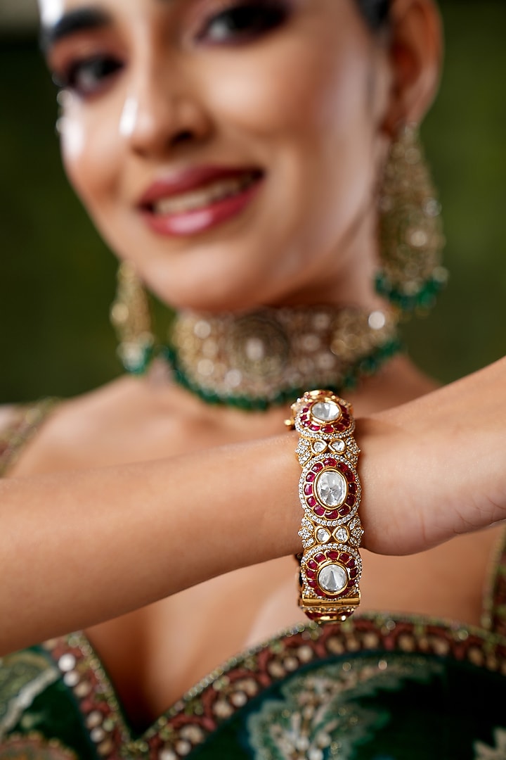 Gold Finish Cubic Zirconia & Red Tourmaline Stone Bangles (Set Of 2) by EKATHVA JAIPUR at Pernia's Pop Up Shop