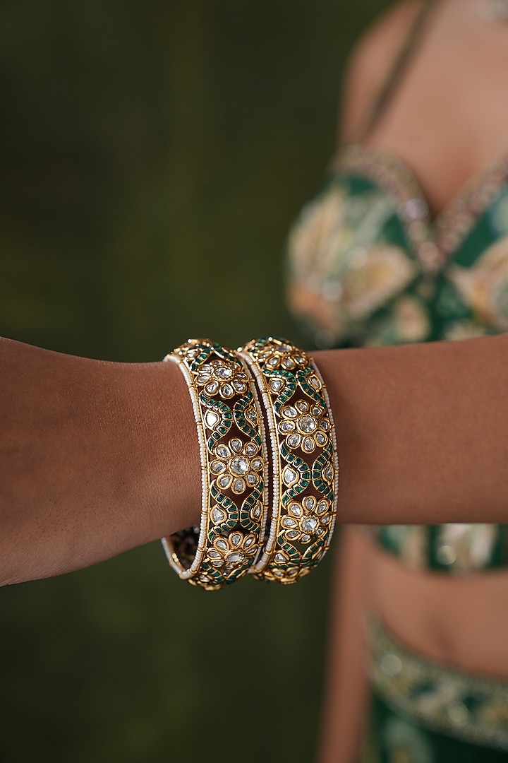 Gold Finish Kundan Polki & Green Stone Bangles (Set Of 2) by EKATHVA JAIPUR at Pernia's Pop Up Shop