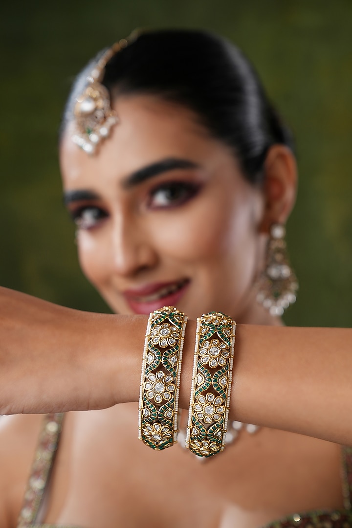 Gold Finish Kundan Polki & Green Stone Bangles (Set Of 2) by EKATHVA JAIPUR at Pernia's Pop Up Shop