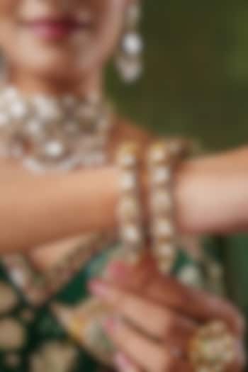 Gold Finish Kundan Polki Bangles (Set Of 2) by EKATHVA JAIPUR at Pernia's Pop Up Shop