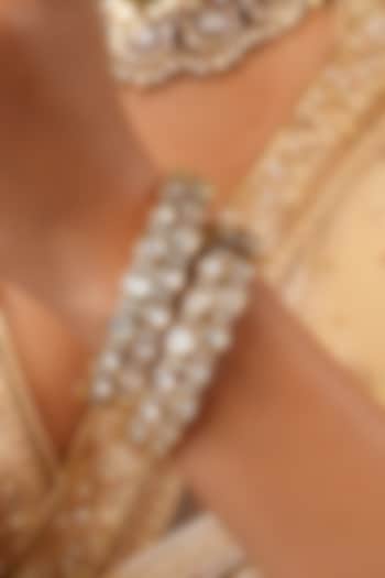 Gold Finish Kundan Polki Floral Bangles (Set Of 2) by EKATHVA JAIPUR at Pernia's Pop Up Shop