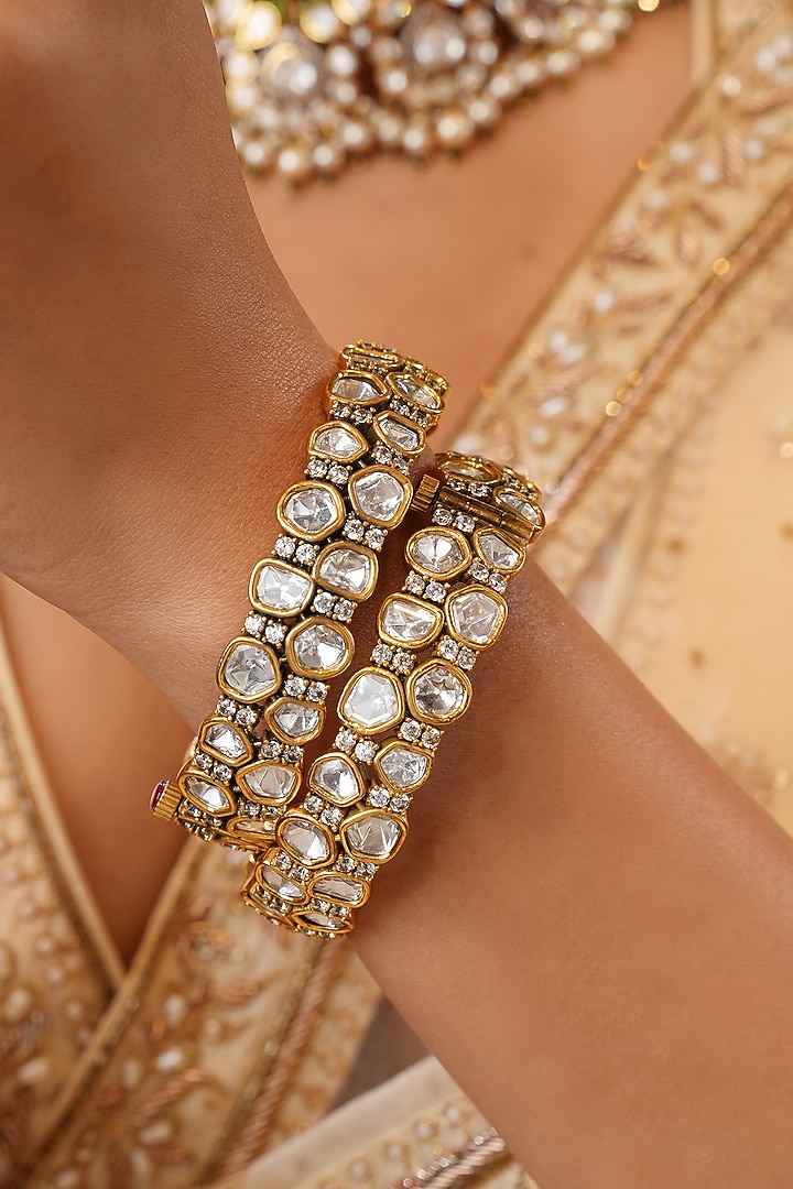Gold Finish Kundan Polki Floral Bangles (Set Of 2) by EKATHVA JAIPUR at Pernia's Pop Up Shop