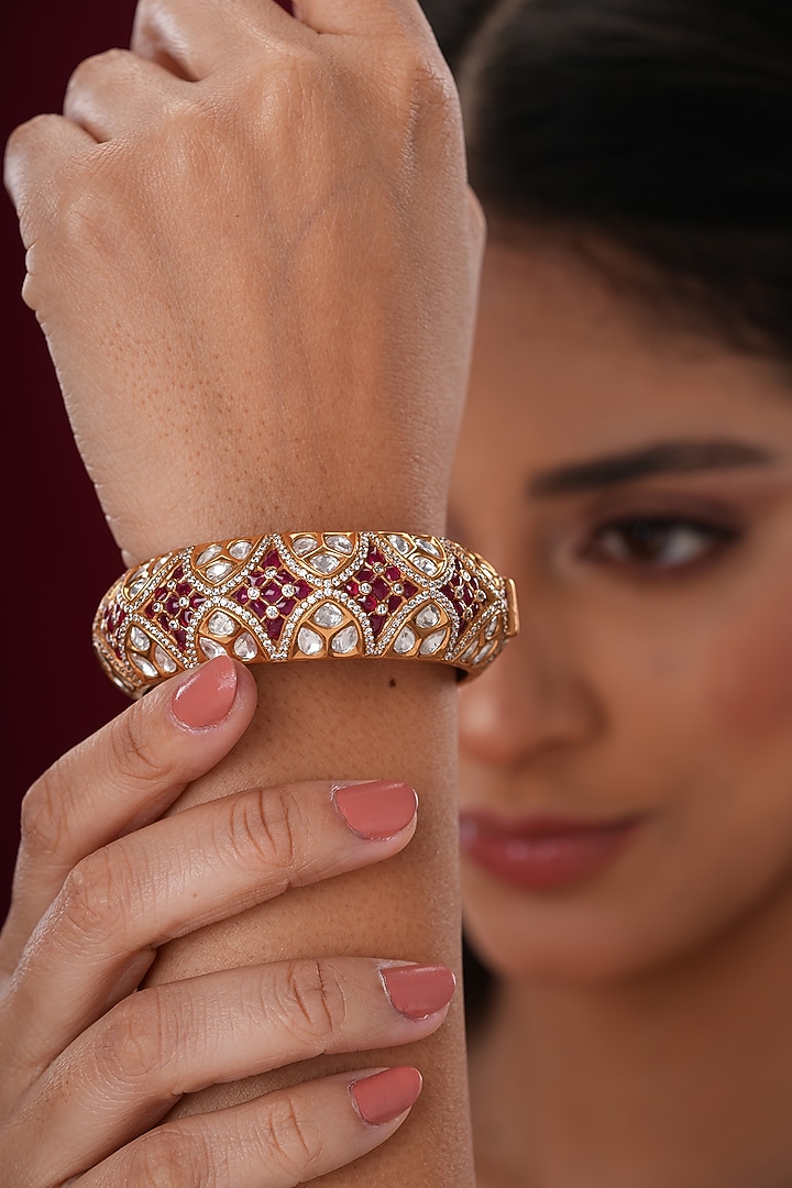 Gold Finish Kundan Polki & Red Stone Bangles (Set Of 2) by EKATHVA JAIPUR at Pernia's Pop Up Shop