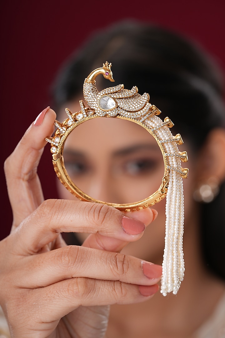 Gold Finish Kundan Polki & Pearl Peacock Bangles (Set Of 2) by EKATHVA JAIPUR at Pernia's Pop Up Shop
