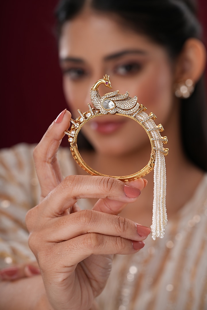 Gold Finish Kundan Polki & Pearl Peacock Bangles (Set Of 2) by EKATHVA JAIPUR at Pernia's Pop Up Shop