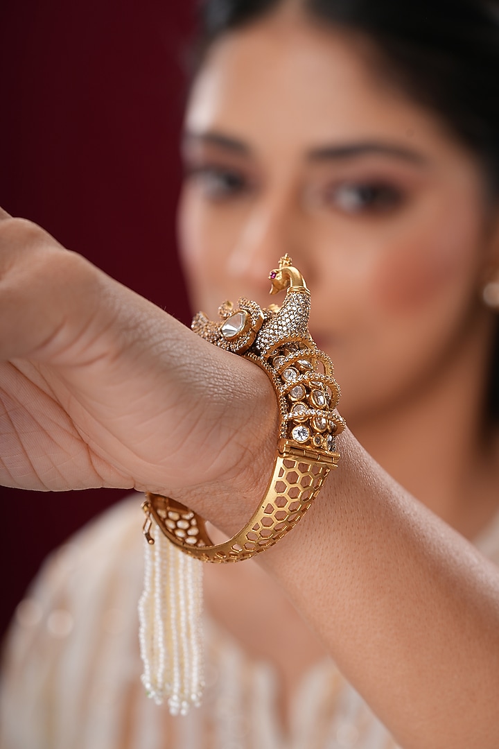 Gold Finish Kundan Polki & Pearl Peacock Bangles (Set Of 2) by EKATHVA JAIPUR at Pernia's Pop Up Shop