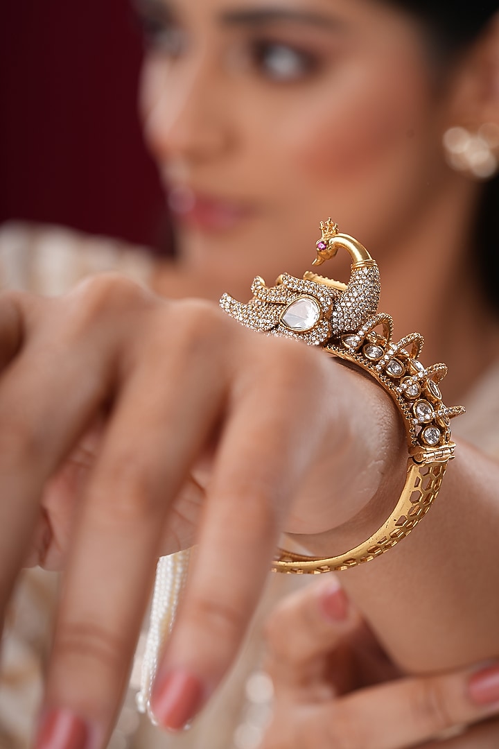 Gold Finish Kundan Polki & Pearl Peacock Bangles (Set Of 2) by EKATHVA JAIPUR at Pernia's Pop Up Shop