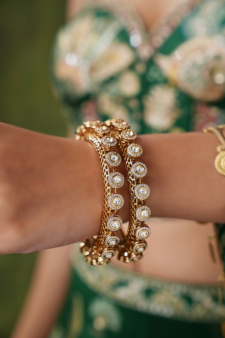 Gold Finish Kundan Polki & Pearl Bangles (Set Of 2) by EKATHVA JAIPUR at Pernia's Pop Up Shop