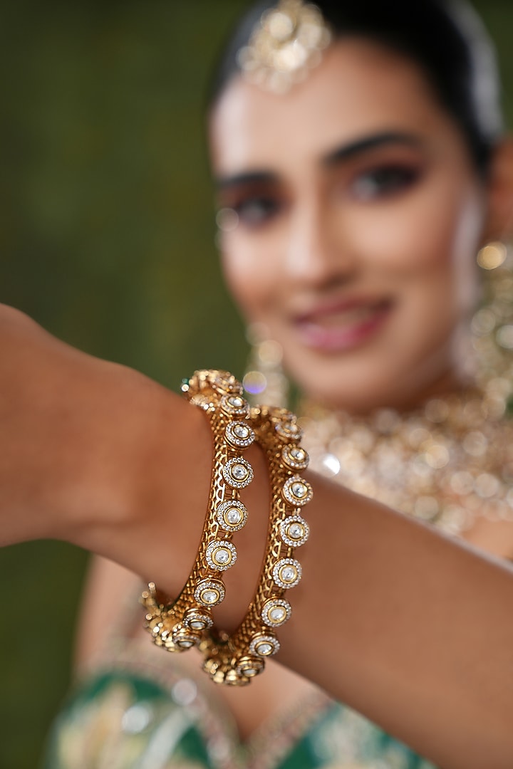 Gold Finish Kundan Polki & Pearl Bangles (Set Of 2) by EKATHVA JAIPUR at Pernia's Pop Up Shop