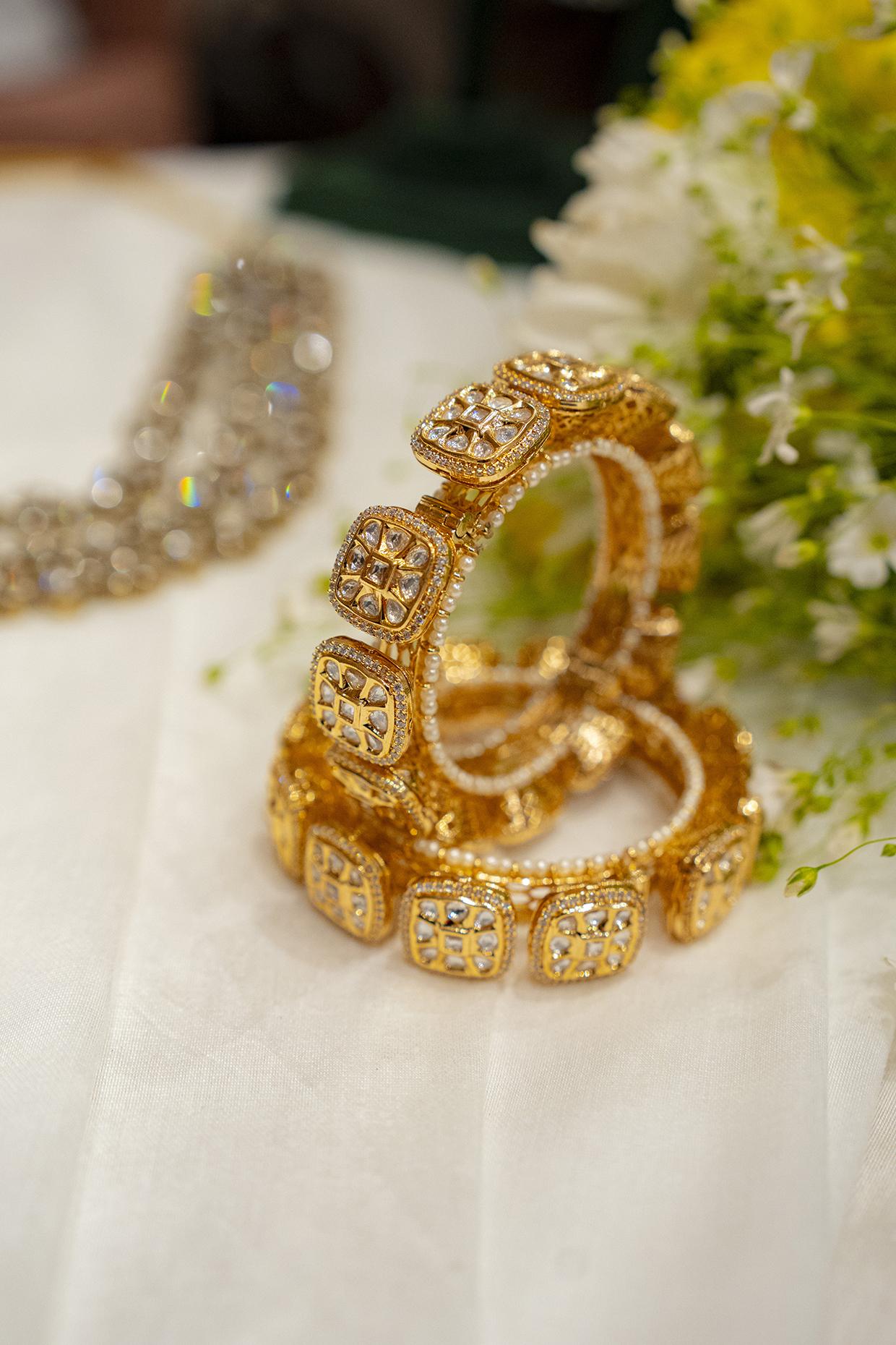 Gold Finish Kundan Polki & Swarovski Pacheli Bangles (Set Of 2) by EKATHVA JAIPUR at Pernia's Pop Up Shop
