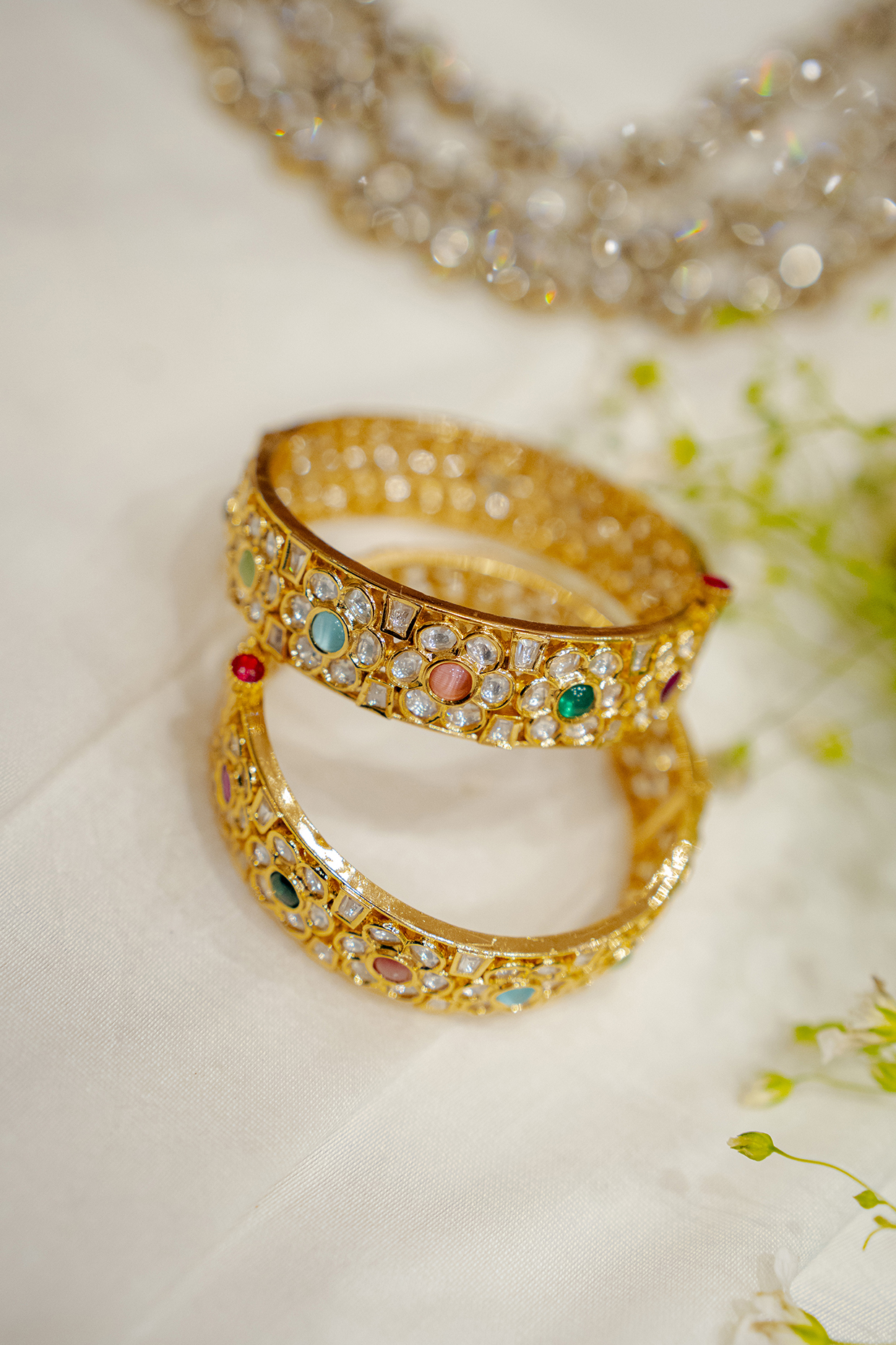 Gold Finish Kundan Polki & Navratna Stone Bangles (Set Of 2) by EKATHVA JAIPUR at Pernia's Pop Up Shop