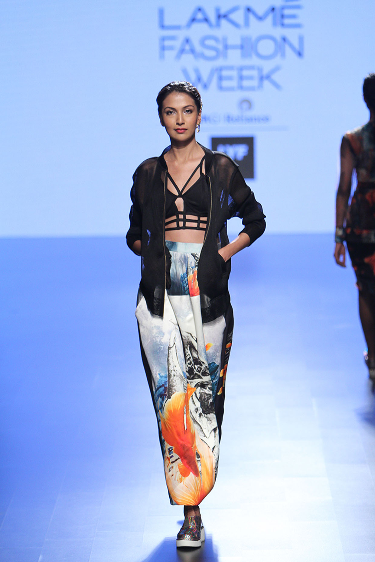 Black bomber jacket and multicoloured fish reflection print skirt available only at Pernia's Pop Up Shop.
