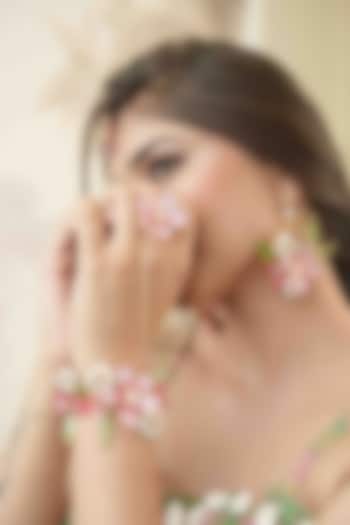 Gold Finish Pink Gemstone & Resin Floral Hathphool (Set of 2) by FLORISTAA BY MAHEK at Pernia's Pop Up Shop