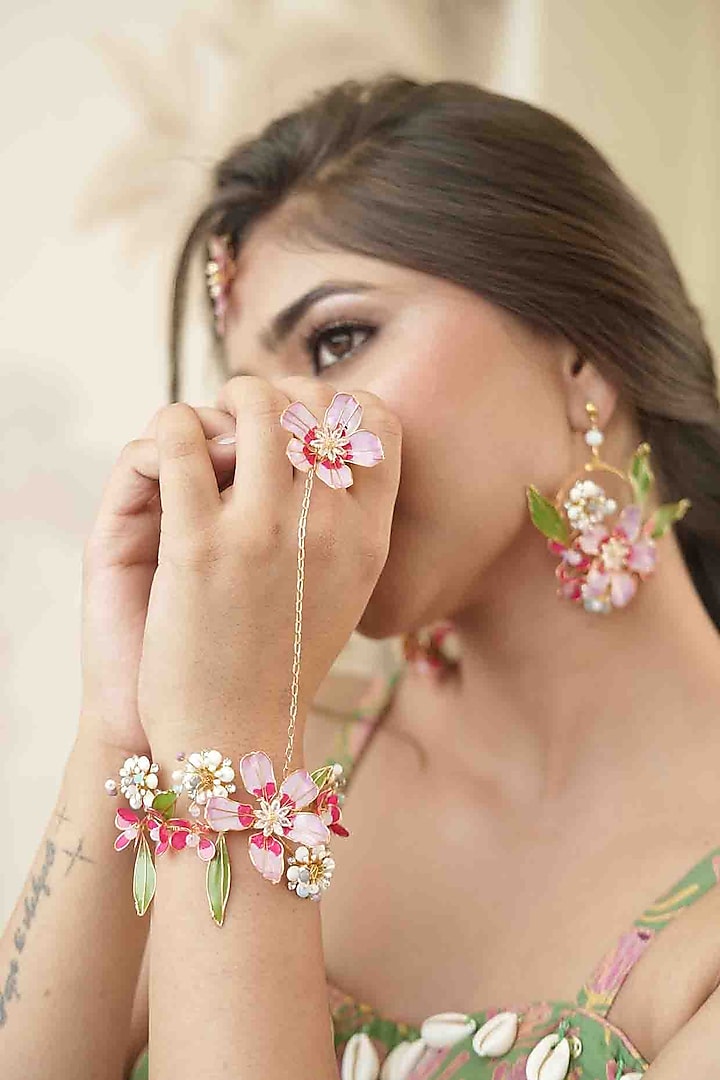 Gold Finish Pink Gemstone & Resin Floral Hathphool (Set of 2) by FLORISTAA BY MAHEK at Pernia's Pop Up Shop