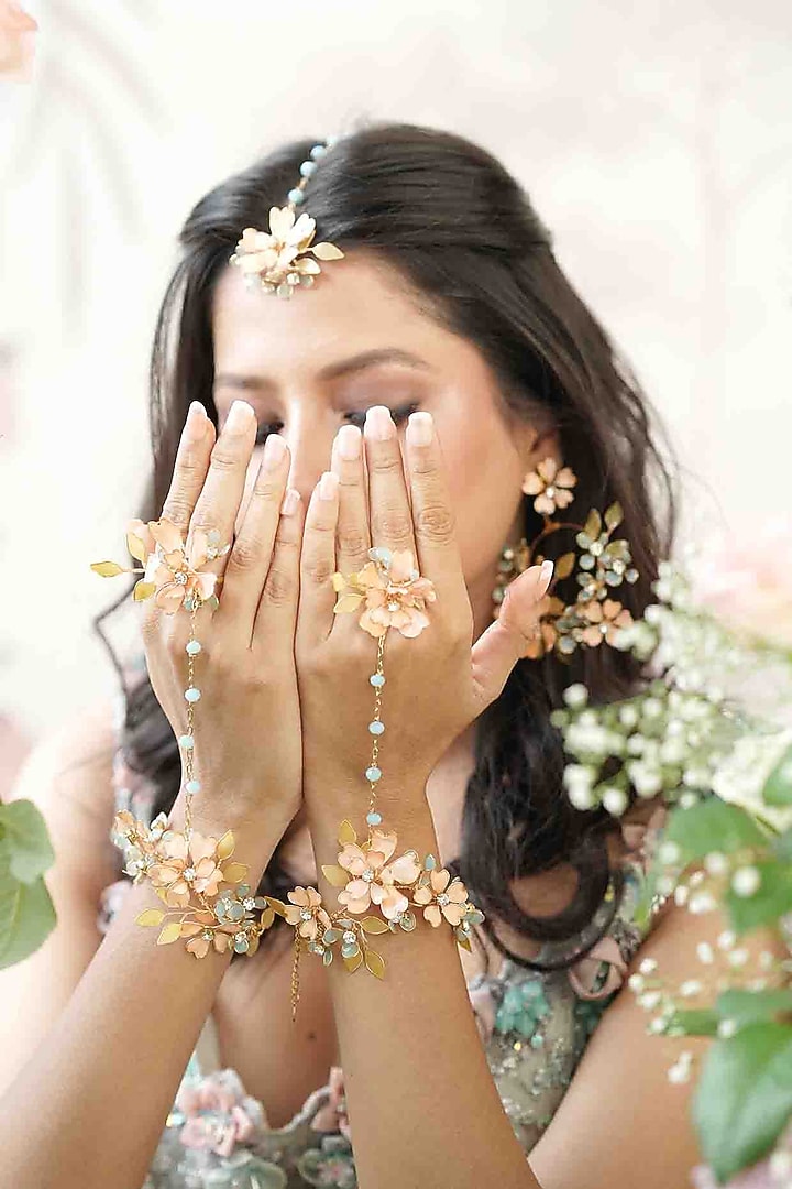 Gold Finish Orange Gemstone & Resin Floral Hathphool (Set of 1) by FLORISTAA BY MAHEK at Pernia's Pop Up Shop