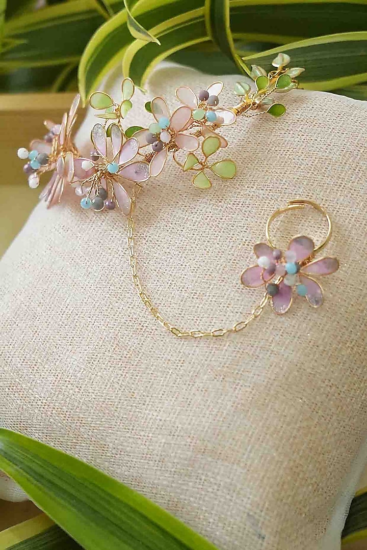 Gold Finish White Gemstone & Resin Floral Hathphool (Set of 2) by FLORISTAA BY MAHEK at Pernia's Pop Up Shop
