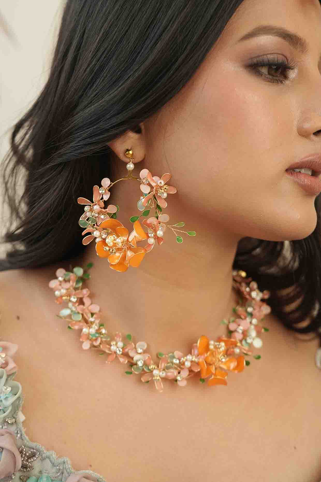Gold Finish Orange Gemstone & Resin Floral Earrings by FLORISTAA BY MAHEK at Pernia's Pop Up Shop
