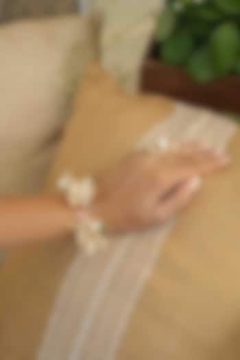 Gold Finish Off-White Gemstone & Resin Floral Hathphool (Set of 2) by FLORISTAA BY MAHEK at Pernia's Pop Up Shop