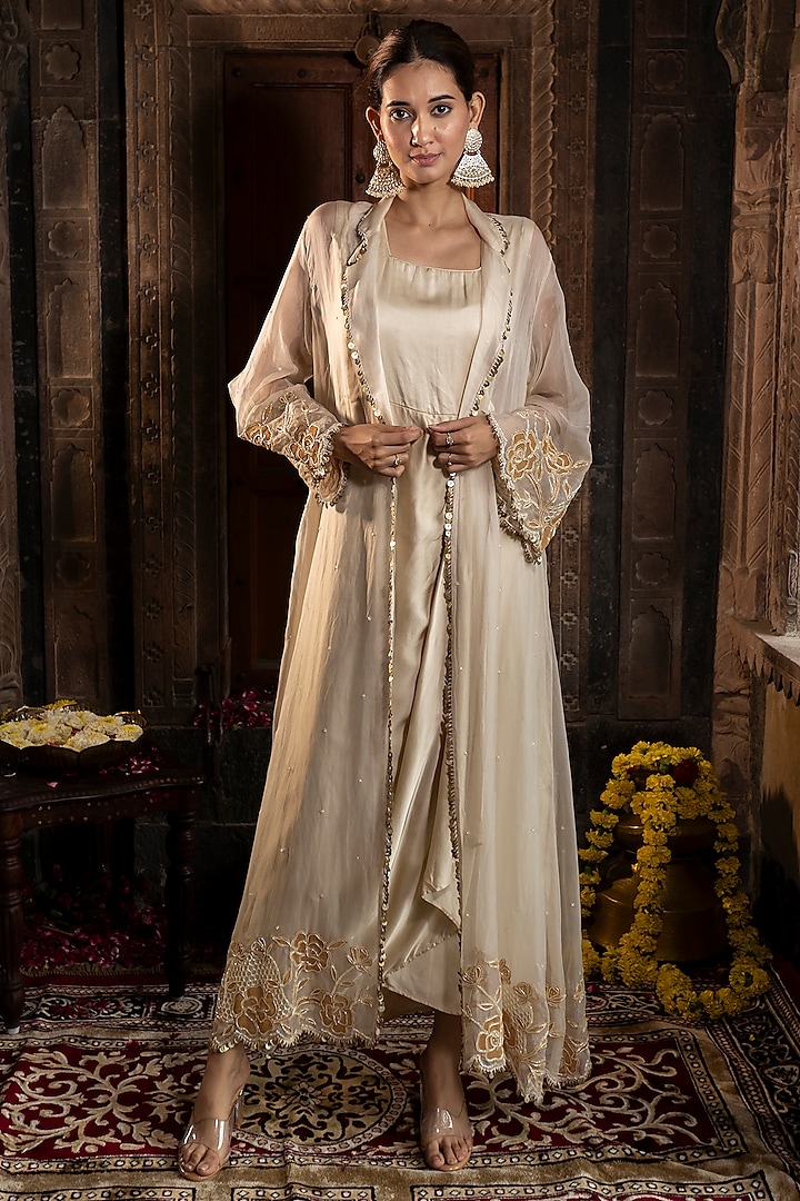 Ivory & Golden Satin Silk Cutdana Hand Embroidered Draped Gown With Jacket by Farha Syed at Pernia's Pop Up Shop