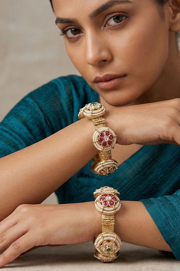 Gold Finish Kundan Polki & Red Stone Bangles (Set Of 2) by Gehna Shop at Pernia's Pop Up Shop