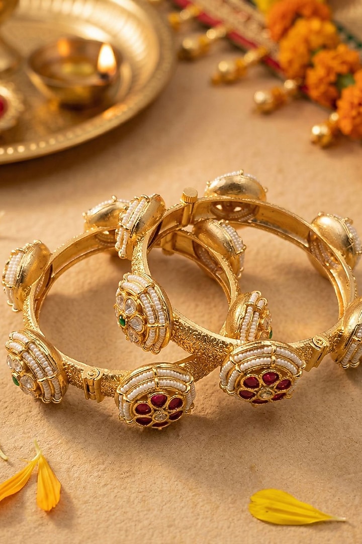 Gold Finish Kundan Polki & Red Stone Bangles (Set Of 2) by Gehna Shop at Pernia's Pop Up Shop