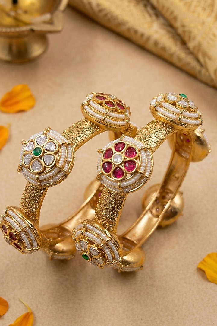 Gold Finish Kundan Polki & Red Stone Bangles (Set Of 2) by Gehna Shop at Pernia's Pop Up Shop