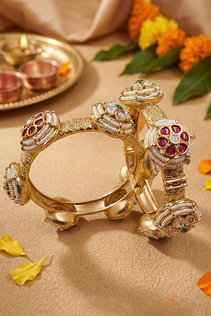 Gold Finish Kundan Polki & Red Stone Bangles (Set Of 2) by Gehna Shop at Pernia's Pop Up Shop