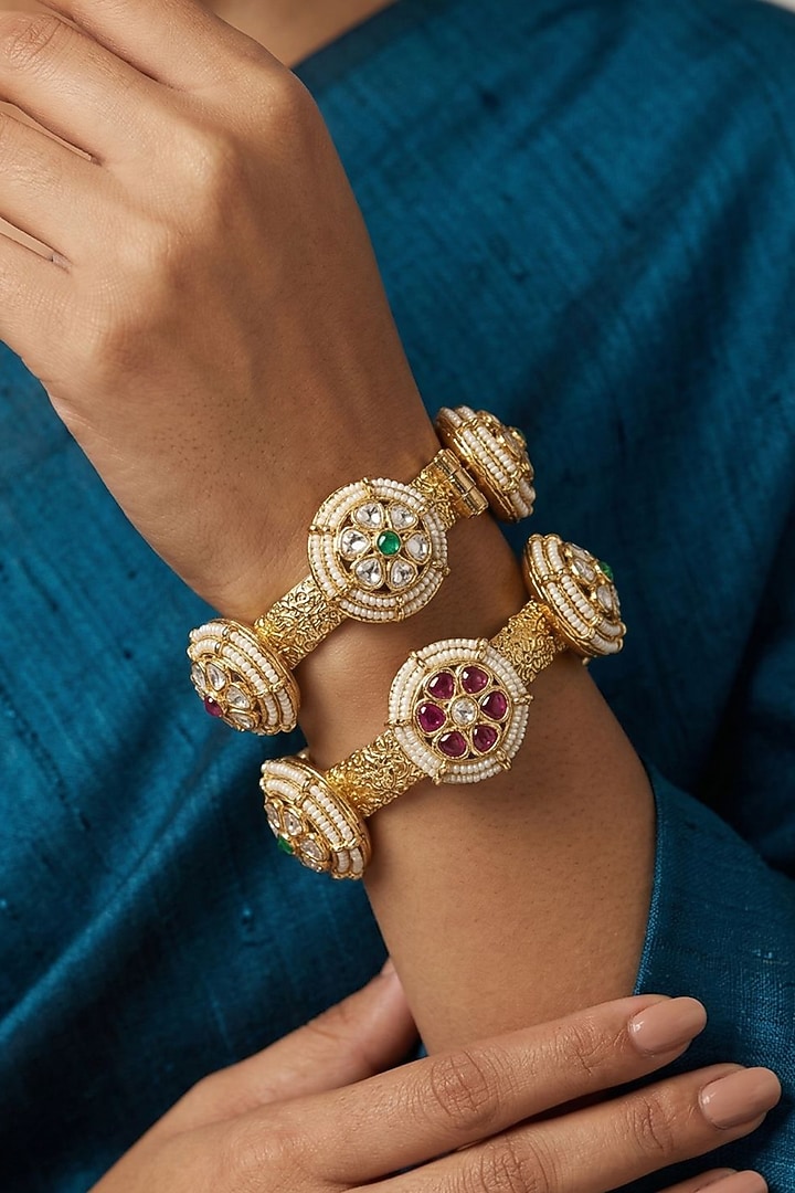 Gold Finish Kundan Polki & Red Stone Bangles (Set Of 2) by Gehna Shop at Pernia's Pop Up Shop