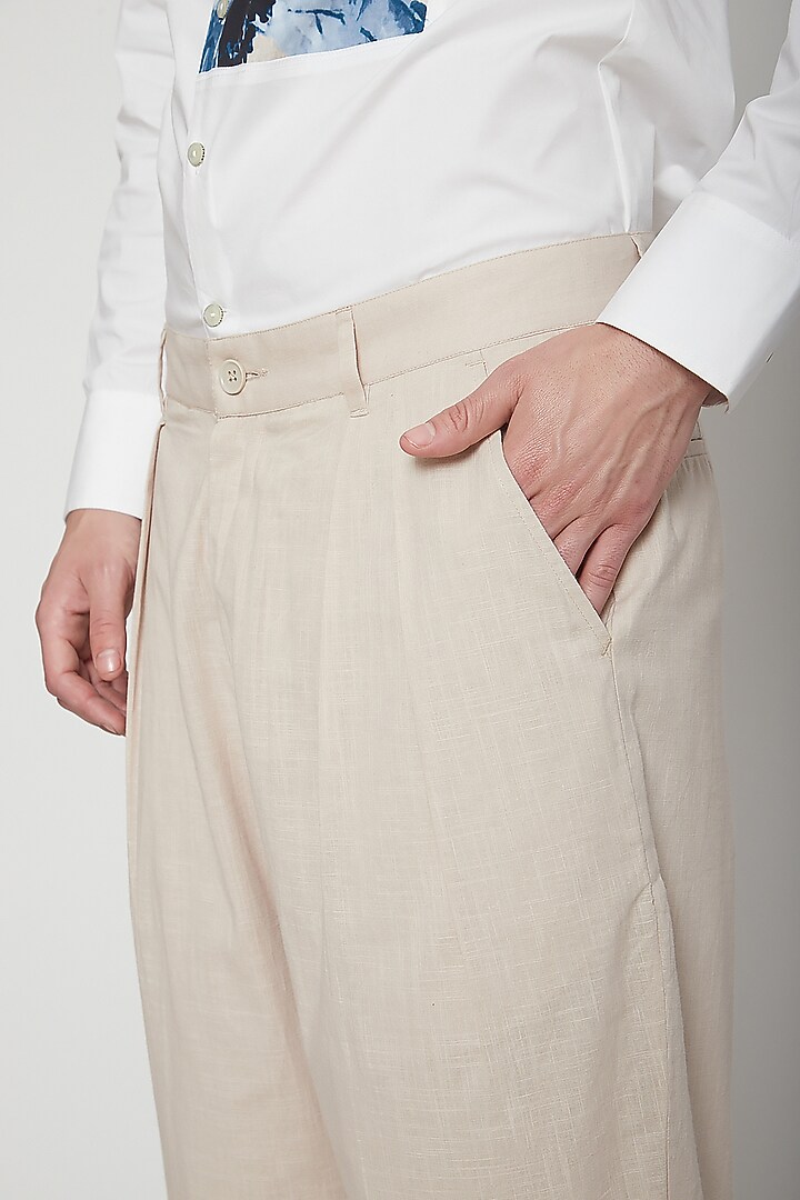 Natural Beige Pleated Trousers by Genes Lecoanet Hemant Men at Pernia's Pop Up Shop