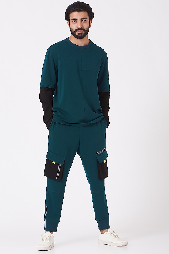 Teal Blue Poly Crepe Trousers by Genes Lecoanet Hemant Men