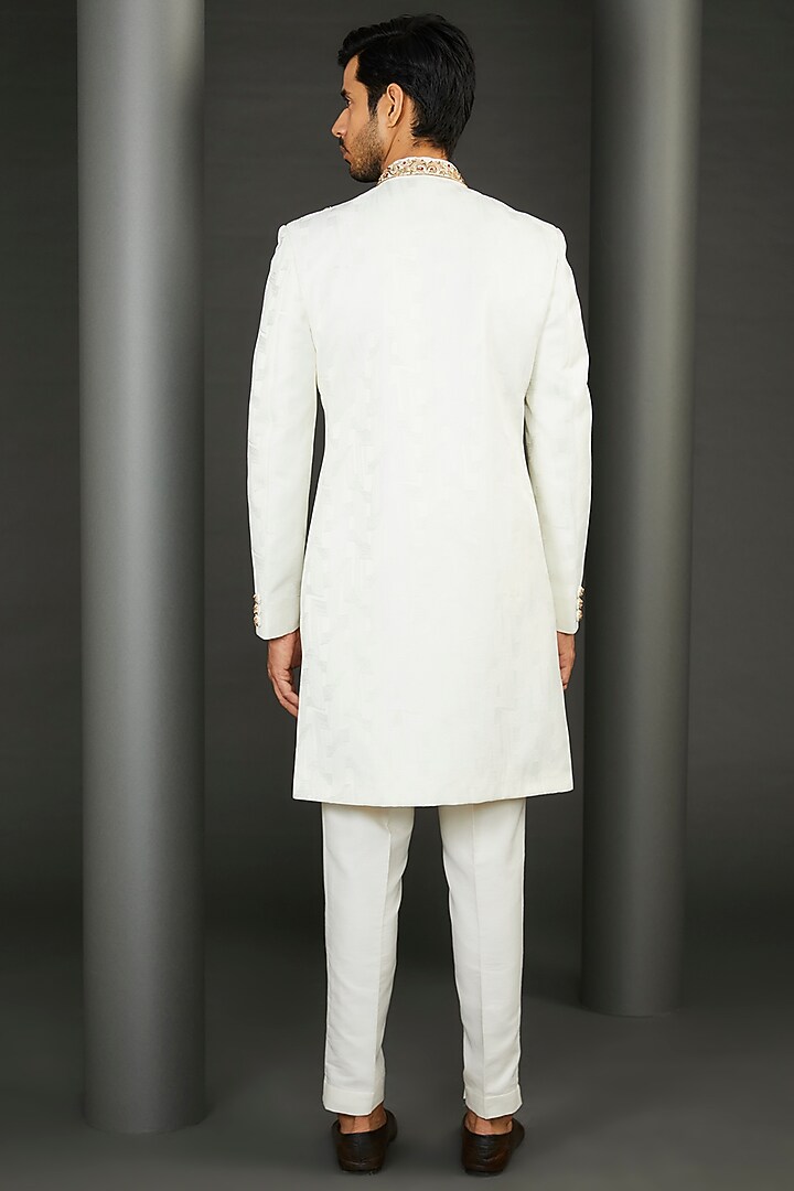 Ivory Jacquard Asymmetric Wedding Sherwani Set by GUJRALS at Pernia's Pop Up Shop