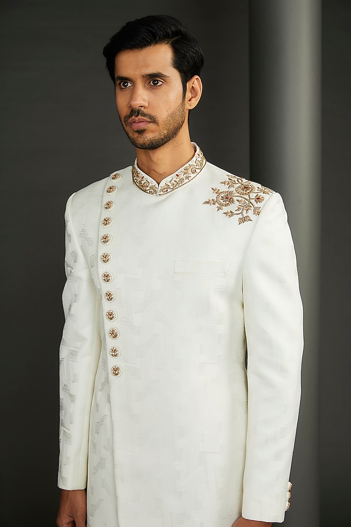 Ivory Jacquard Asymmetric Wedding Sherwani Set by GUJRALS at Pernia's Pop Up Shop