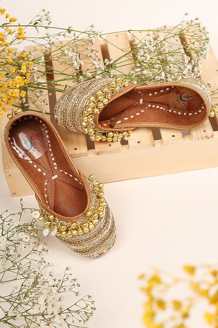 Golden Leatherette Embellished Juttis For Girls by Hello Jr at Pernia's Pop Up Shop