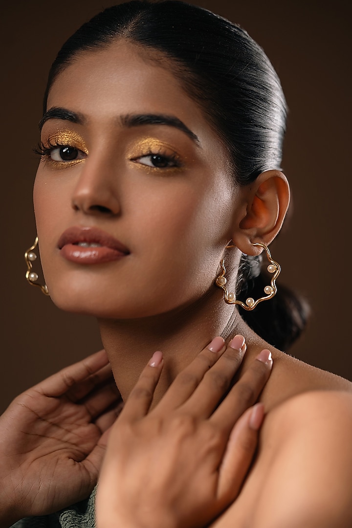 Gold Finish Pearl Handcrafted Swirl Hoop Earrings by Hermosa By Srishti Bajaj at Pernia's Pop Up Shop