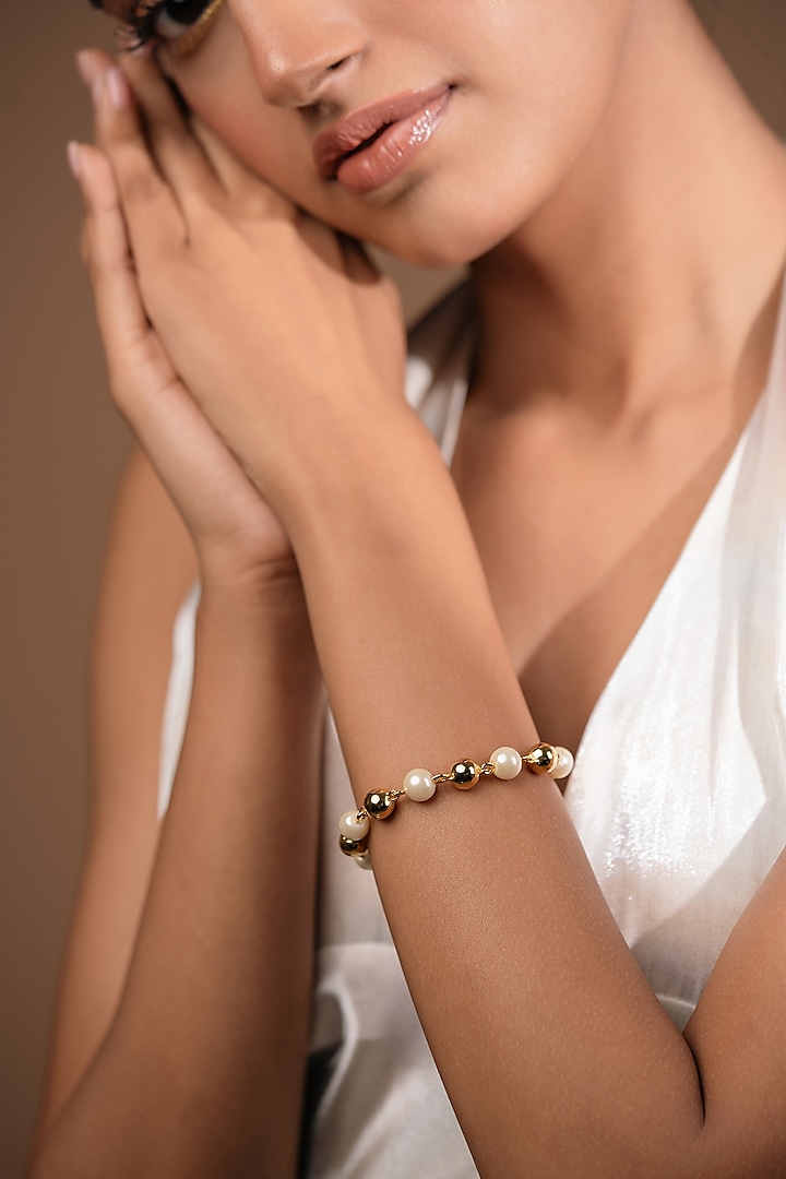 Gold Finish Pearl Bracelet by Hermosa By Srishti Bajaj at Pernia's Pop Up Shop