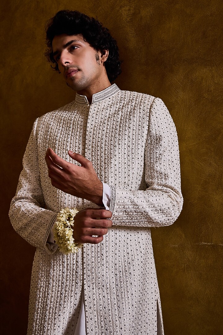 Ivory Raw Silk Resham Embroidered Groom Sherwani Set by NITIKA GUJRAL MEN at Pernia's Pop Up Shop