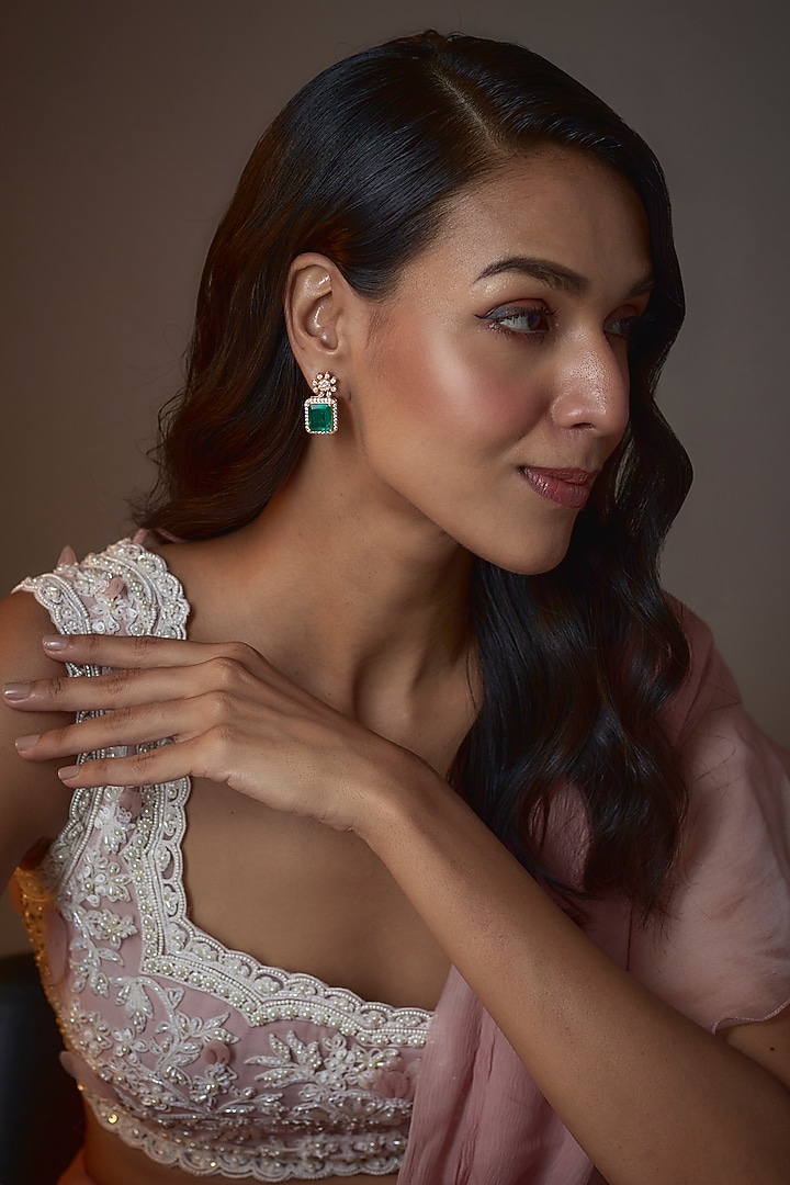 Gold Finish Moissanite Polki & Synthetic Emerald Stud Earrings In Sterling Silver by Hunar at Pernia's Pop Up Shop