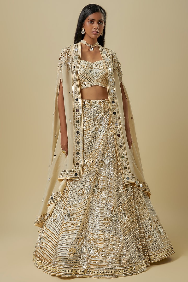 Ivory Gold Silk Shantoon & Hard Net Cape Bridal Lehenga Set by I AM DESIGN at Pernia's Pop Up Shop