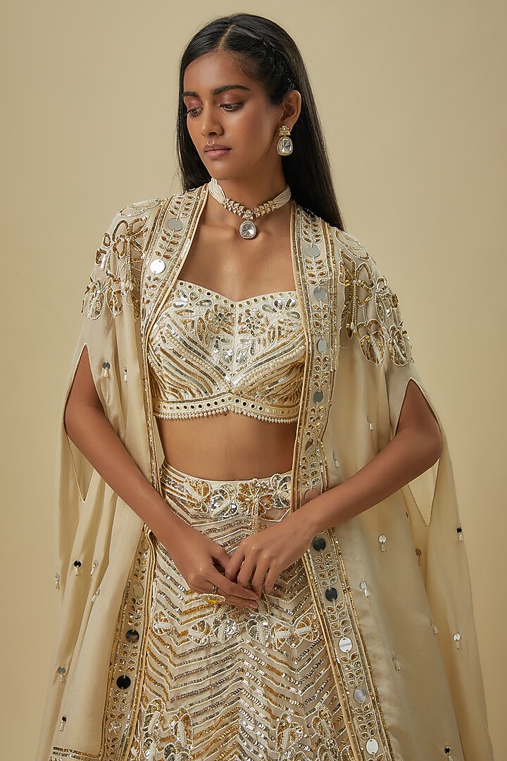 Ivory Gold Silk Shantoon & Hard Net Cape Bridal Lehenga Set by I AM DESIGN at Pernia's Pop Up Shop