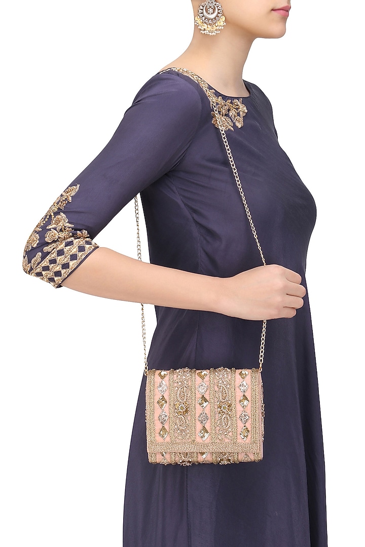 Inayat presents Blush peach and gold embroidered flapover clutch available only at Pernia's Pop Up Shop.