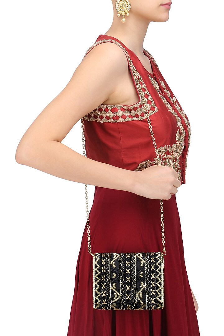 Inayat presents Black and gold zigzag embroidered flapover clutch available only at Pernia's Pop Up Shop.