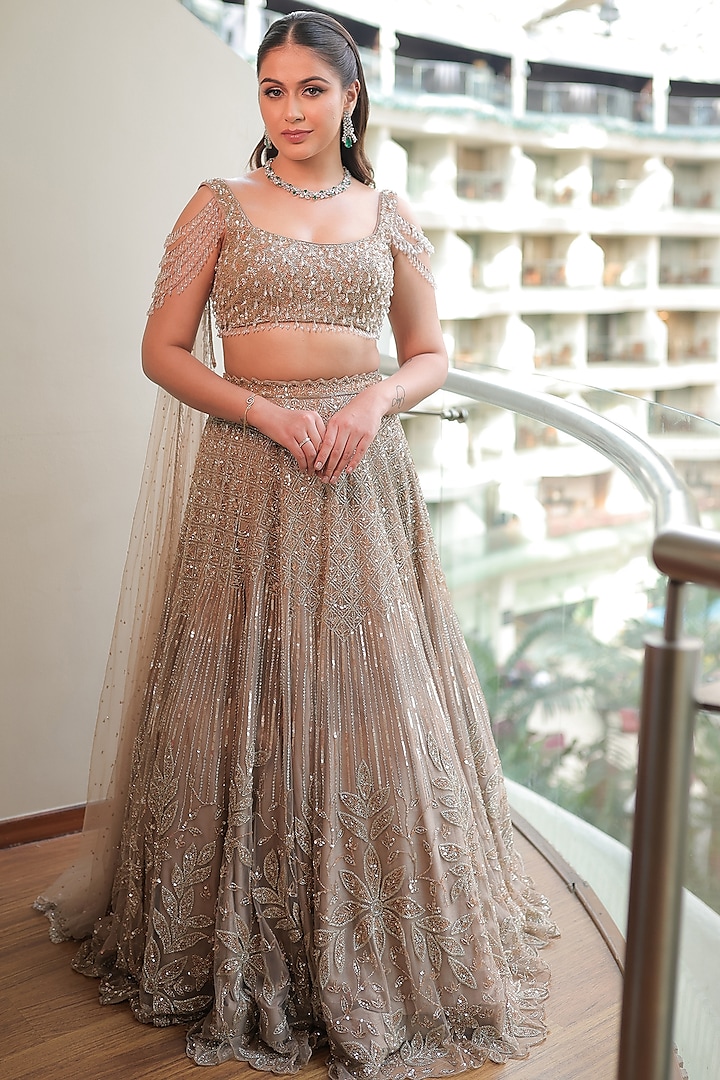 Beige Gold Net Embroidered Lehenga Set by Isa by Dolly Wahal