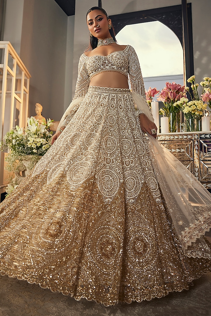 Ivory & Gold Net Sequins & Cutdana Embroidered Bridal Lehenga Set by Isa by Dolly Wahal at Pernia's Pop Up Shop