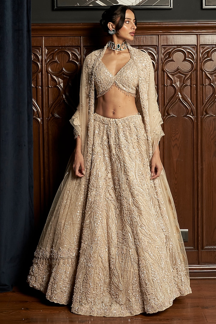 Beige Net Applique Embroidered Bridal Lehenga Set by ISTYA at Pernia's Pop Up Shop