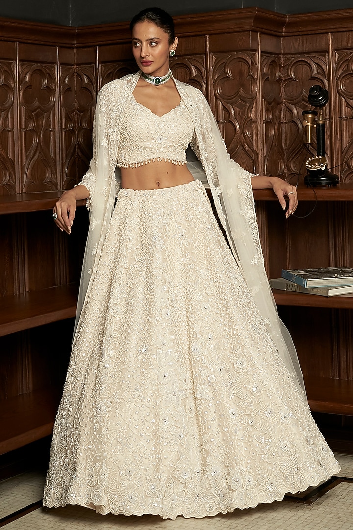 Ivory Net Applique Embellished Bridal Lehenga Set by ISTYA at Pernia's Pop Up Shop